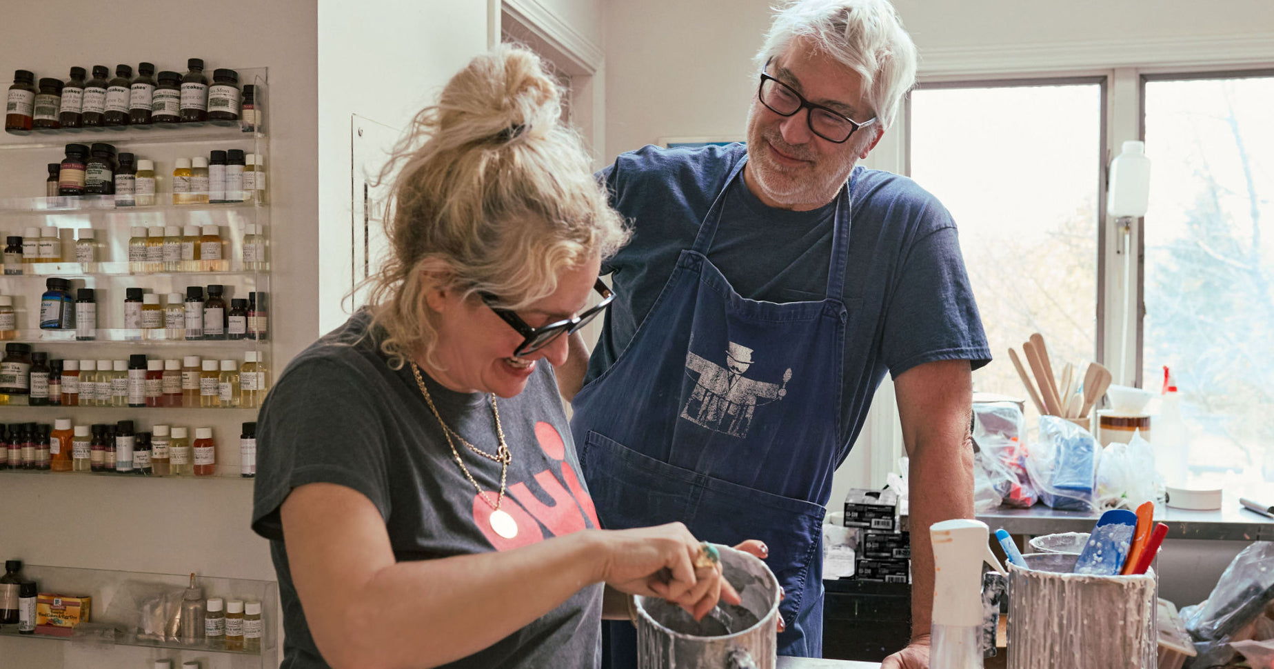 Linda and John Meyers making soap using a bucket.