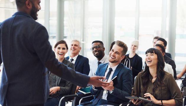 People at a conference listening to speaker.